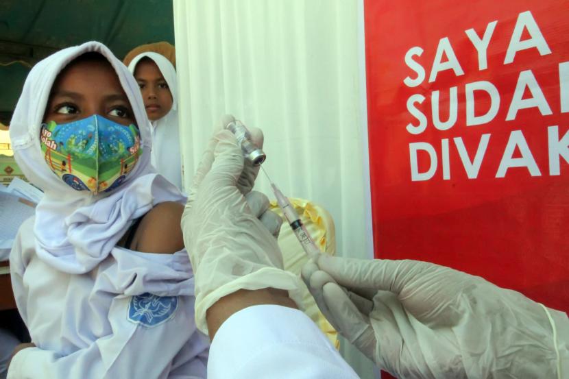 Siswa melihat petugas kesehatan mempersiapkan cairan vaksin COVID-19 jenis Sinovac di SD Negeri 1 Lhokseumawe, Aceh, Kamis (20/1/2022). Vaksinasi yang digelar Dinas Kesehatan Pemko Lhokseumawe bersama kepolisian tersebut sebagai upaya percepatan vaksinasi COVID-19 bagi anak usia 6-11 tahun untuk persiapan pembelajaran tatap muka (PTM) 100 persen.