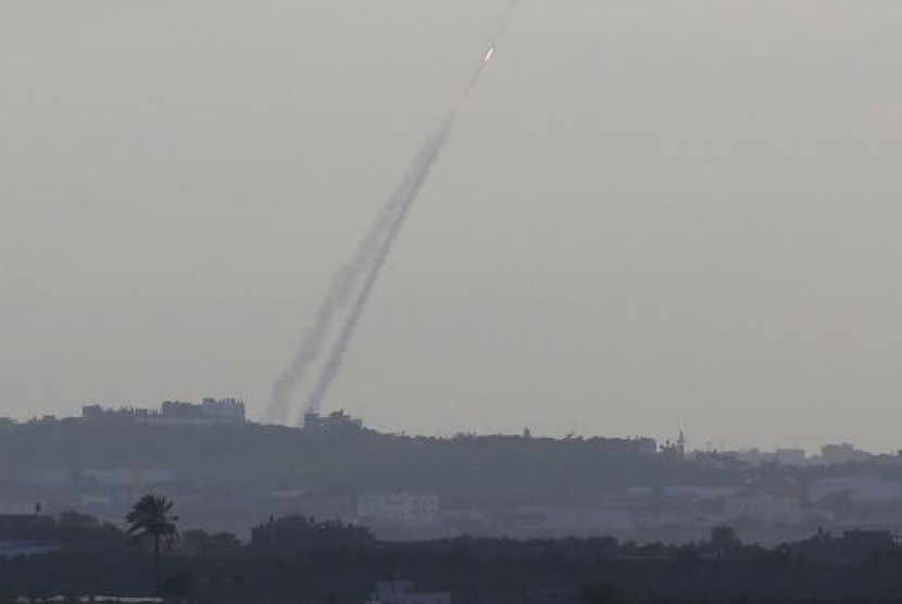 Smoke trails are seen as a rocket is launched from the northern Gaza Strip towards Israel July 15, 2014.