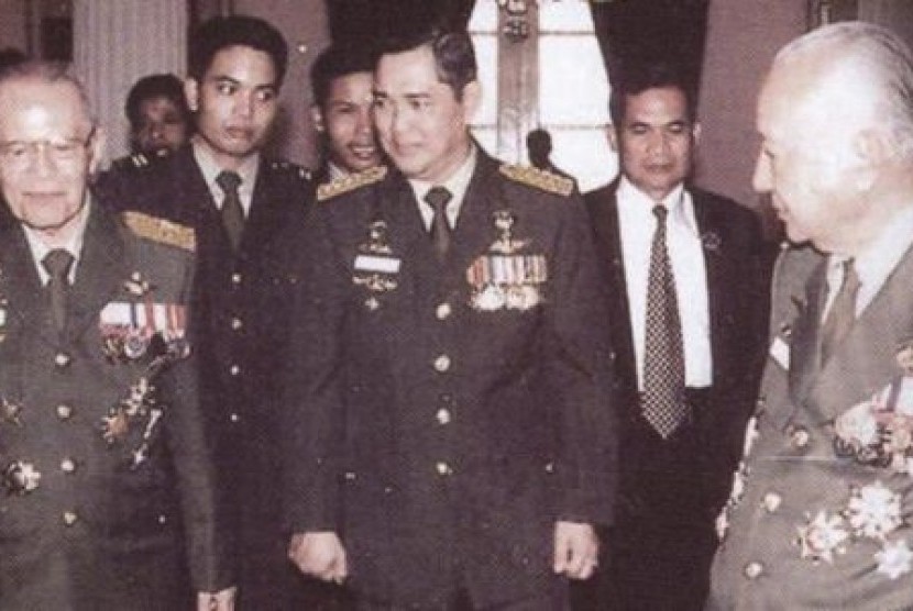 Presiden Soeharto tampak sangat merakyat dengan mebubuhkan tanda tangan dengan punggung seseorang.
