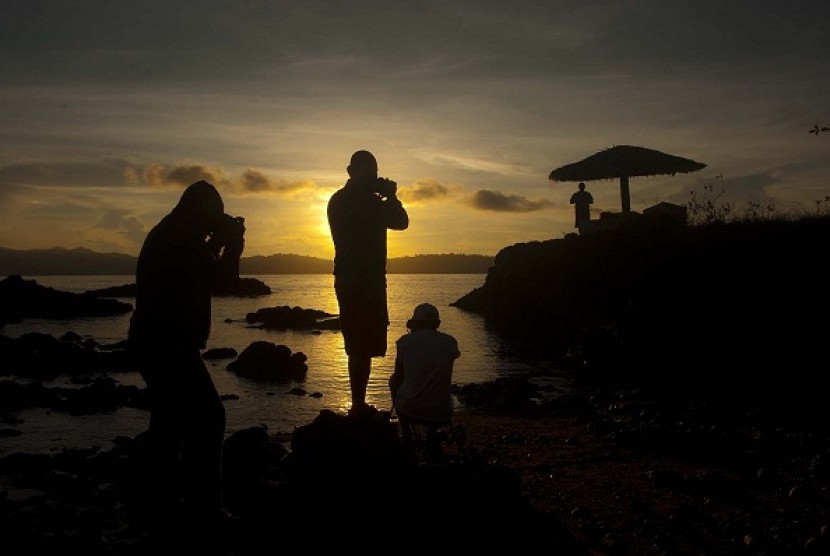 Some tourists capture the sunrise in Desa Tulehu, Ambon. The island offers a number of potentials for tourism and other economic cooperations. (illustration)