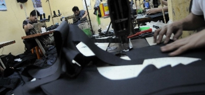 Some workers sew material for bags in a small enterprises in Manggarai, Jakarta. (illustration) 