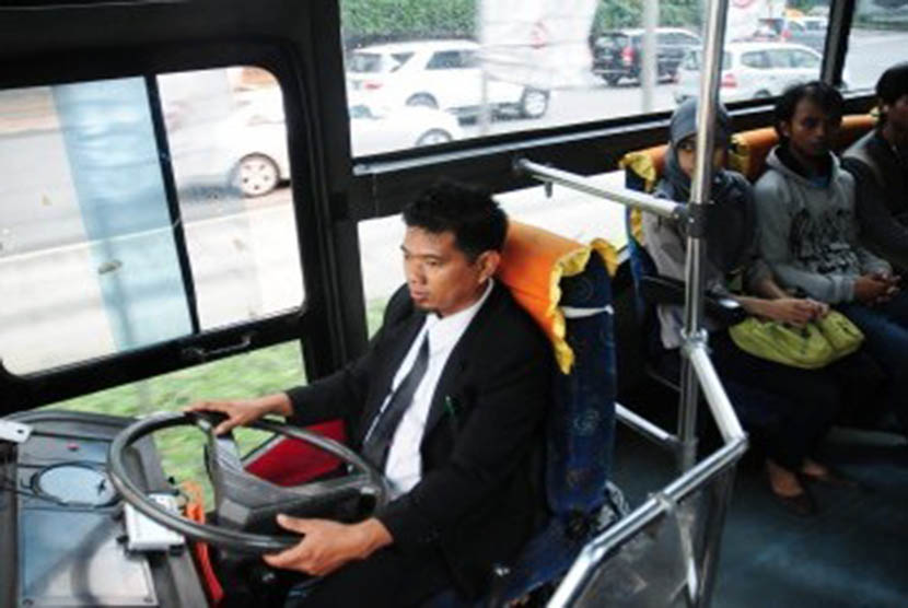 Sopir mengemudikan bus Transjakarta. Meski memiliki stiker polisi, pemukul sopir Transjakarta bukan anggota dan keluarga polisi.