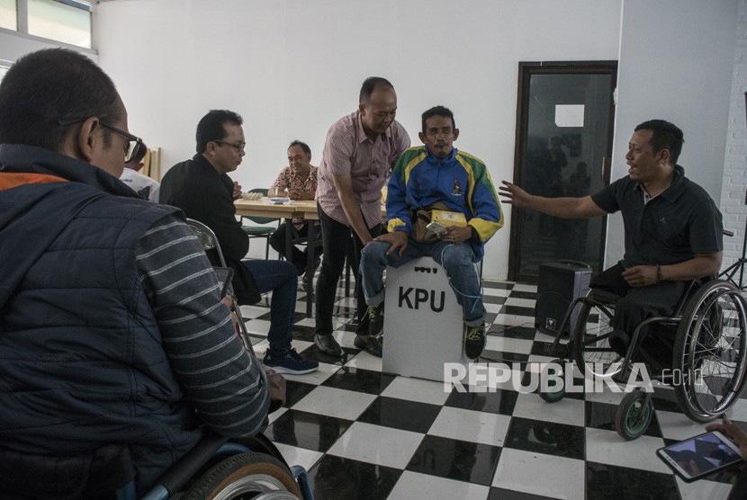 Sosialisasi Pemilu Untuk Disabilitas. Warga penyandang disabilitas mencoba duduk di atas kotak suara untuk mengetahui kekuatan kotak suara tersebut pada acara Sosialisasi dan Pendidikan Bagi Pemilih Disabillitas pada Pemilu 2019 di GOR Pajajaran, Bandung, Jawa Barat, Rabu (27/2/2019). 