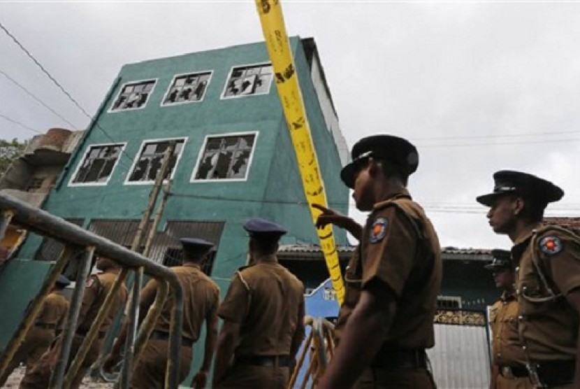 Sri Lankan police officers patrol outside a vandalized mosque in Colombo, Sri Lanka, Sunday, Aug. 11, 2013. 