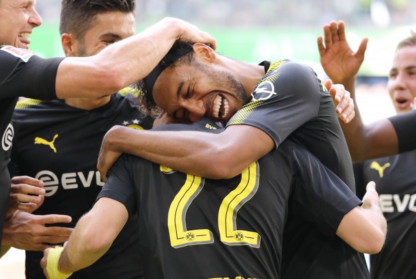 Striker Borussia Dortmund, Pierre-Emerick Aubameyang (tengah) merayakan gol ke gawang Vfl Wolfsburg pada laga Bundesliga di Volkswagen Arena, Sabtu (19/8). Dortmund menang 3-0.