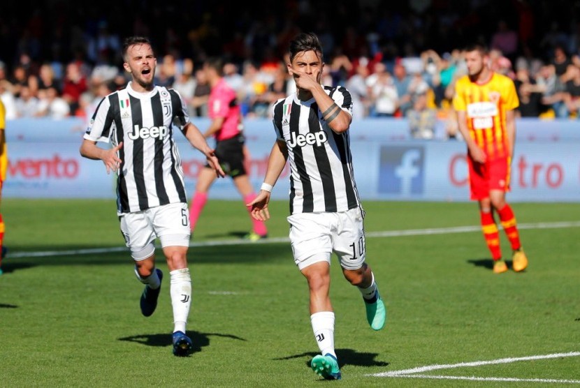 Striker Juventus, Paolo Dybala (kanan) merayakan gol ke gawang Benevento pada laga lanjutan Serie A, Sabtu (7/4).