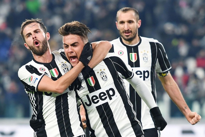 Striker Juventus, Paolo Dybala (tengah) merayakan gol ke gawang Bologna pada laga Serie A di stadion Juventus, Senin (9/1) dini hari WIB. Juve menang 3-0.