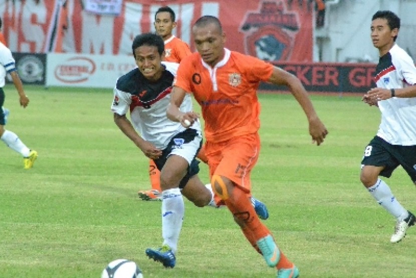 Striker Persisam Putra Samarinda, Ferdinand Sinaga, dikawal ketat pemain belakang Pelita Bandung Raya (PBR), Edi Hafid.