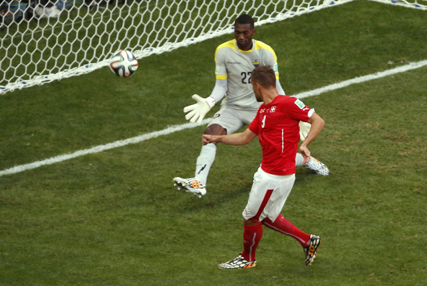 Striker Timnas Swiss, Haris Seferovic, melepaskan tembakan menjebol gawang kiper Ekuador, Alexander Dominguez, dalam laga Grup E Piala Dunia 2014 di Stadion Nasional, Brasilia, Ahad (15/6). 