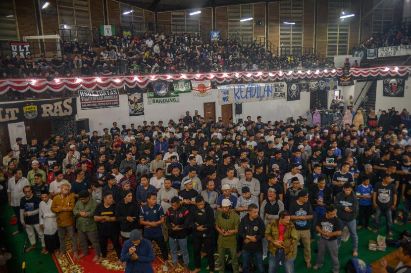 Suporter dari berbagai klub sepak bola mengikuti doa bersama dan Shalat Gaib di gor saparua Bandung, Jawa Barat, Sabtu (8/10/2022). Doa bersama dan Shalat Gaib yang diikuti dari berbagai unsur suporter klub di Liga 1 tersebut ditujukan untuk korban yang meninggal di Stadion Kanjuruhan. 
