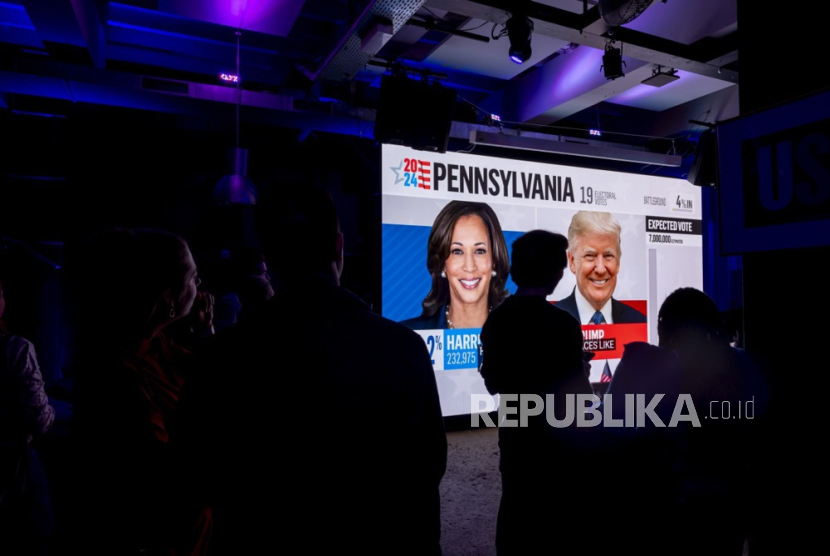 Supporters of Democratic presidential nominee Vice President Kamala Harris look at the first results, during the US election night party, in Geneva, Switzerland, 05 November 2024. 