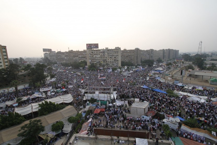 Supporters of the ousted President Mohammed Mursi shout slogans in Nasr City, asuburb of Cairo, Egypt, Monday, July 8, 2013. 