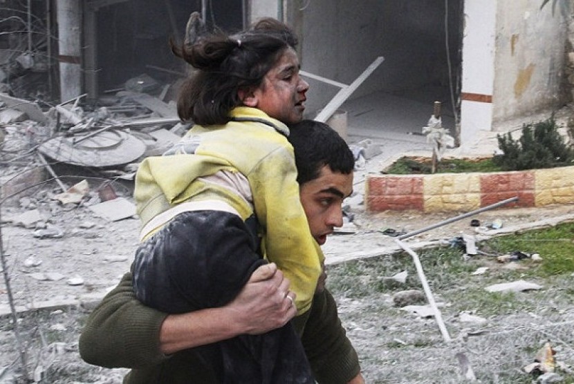 Syrian man carries his sister who was wounded in a government airstrike hit the neighborhood of Ansari, in Aleppo, Syria, on Sunday. (file photo)