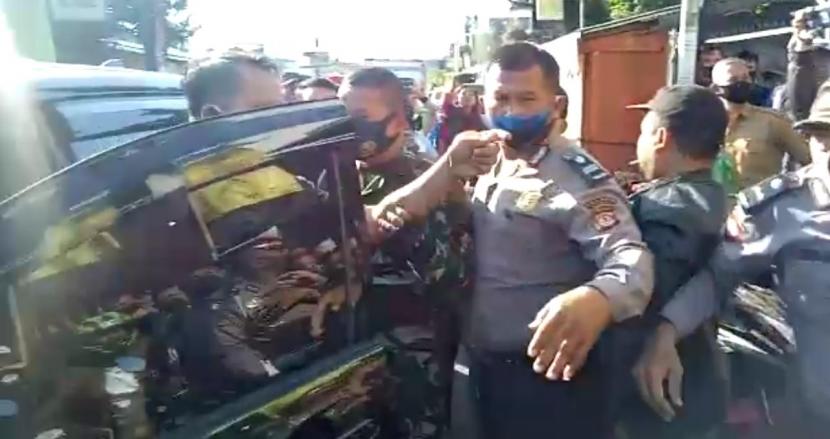Tangkapan layar oknum kepolisian di Kabupaten Garut yang diduga melontarkan ancaman ke kerumunan massa saat terjadi kericuhan di gedung PGRI Kabupaten Garut, Selasa (28/7). 