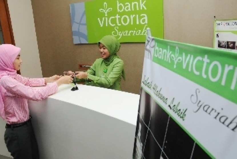 Teller melayani nasabah di Bank Victoria Syariah, Senayan, Jakarta.