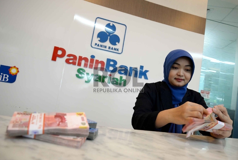  Teller menghitung uang rupiah di Banking Hall Bank, Jakarta, Senin (27/4).  (Republika/ Yasin Habibi)