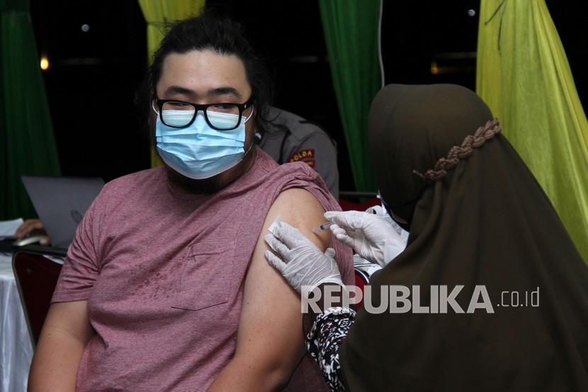 Tenaga kesehatan menyuntikkan vaksin COVID-19 kepada warga saat vaksinasi akhir pekan di halaman Kantor Gubernur Kalbar di Pontianak, Kalimantan Barat, Ahad (6/3/2022) malam. Dinas Kesehatan Provinsi Kalbar mencatat hingga Sabtu (5/3/2022) sebanyak 3.268.104 orang (84,39 persen) telah menjalani vaksinasi COVID-19 untuk vaksin tahap pertama, 2.376.300 orang (61,36 persen) untuk vaksin tahap kedua dan 143.163 orang (3,7 persen) untuk tahap ketiga di wilayah Kalimantan Barat.  Masyarakat Diimbau tidak Pilih-Pilih Vaksin Covid-19
