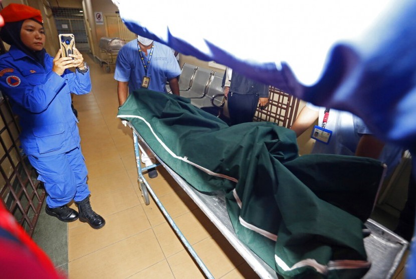 Tenaga medis membawa jenazah perempuan Kaukasia ke ruang jenazah di Seremban, Negeri Sembilan, Malaysia, Selasa (13/8). Jenazah tersebut diduga gadis Inggris yang hilang 10 hari lalu.