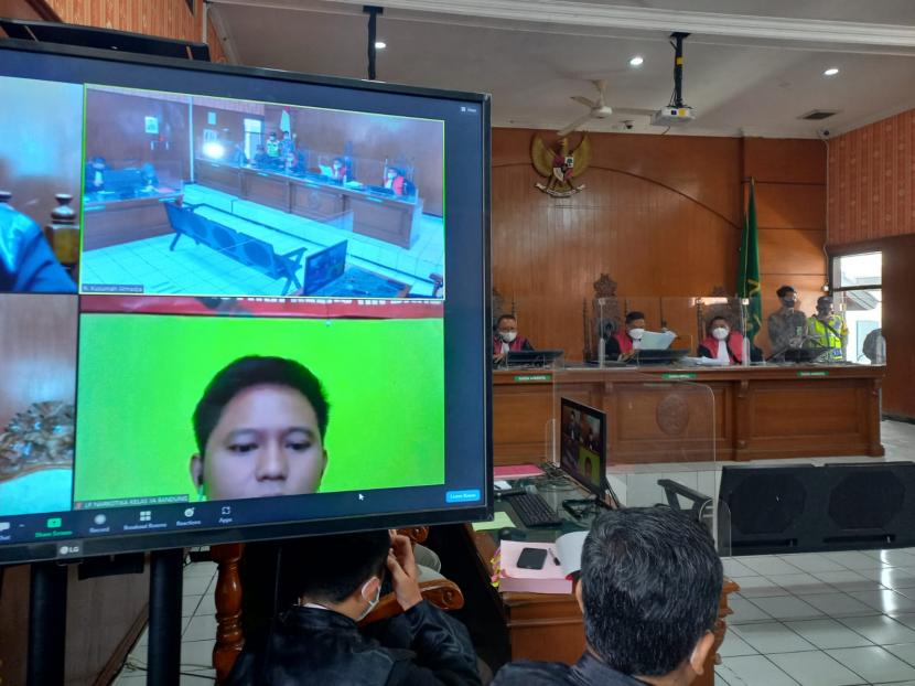 Terdakwa kasus investasi aplikasi Qoutex Doni Salmanan tengah mendengarkan majelis hakim membacakan putusan vonis di PN Bale Bandung, Kamis (15/12/2022). Doni ikut sidang secara online dari LapasJelekong. 