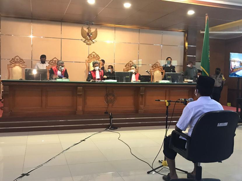 Terdakwa kasus pelecehan seksual terhadap 13 santriwati Herry Wirawan tengah mendengarkan pembacaan vonis yang dibacakan majelis hakim di PN Bandung, Selasa (15/2/2022). 