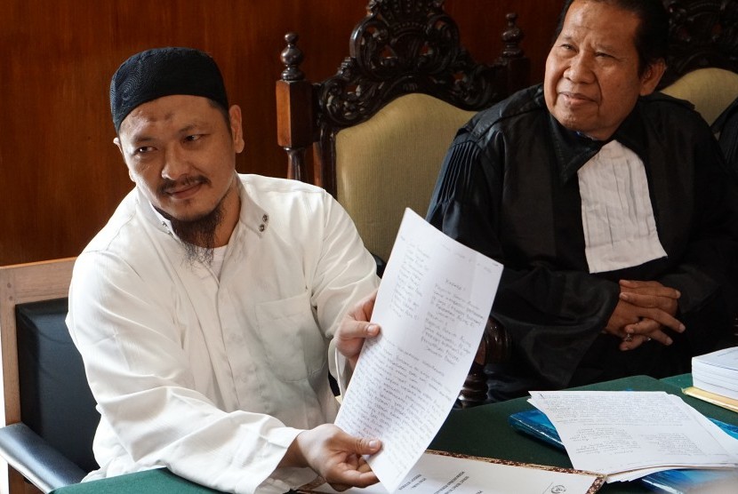 Terpidana mati kasus narkoba Freddy Budiman (kiri), menunjukkan surat permohonan tobat nasuha pada sidang PK di Pengadilan Negeri Cilacap, Jawa Tengah, Rabu (25/5).