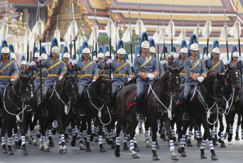 Thai Royal Guards ride their horses in front of the Grand Palace, during a military parade as a part of a celebration for the upcoming birthday of Thailand's King Bhumibol Adulyadej, in Bangkok, December 2, 2014. 