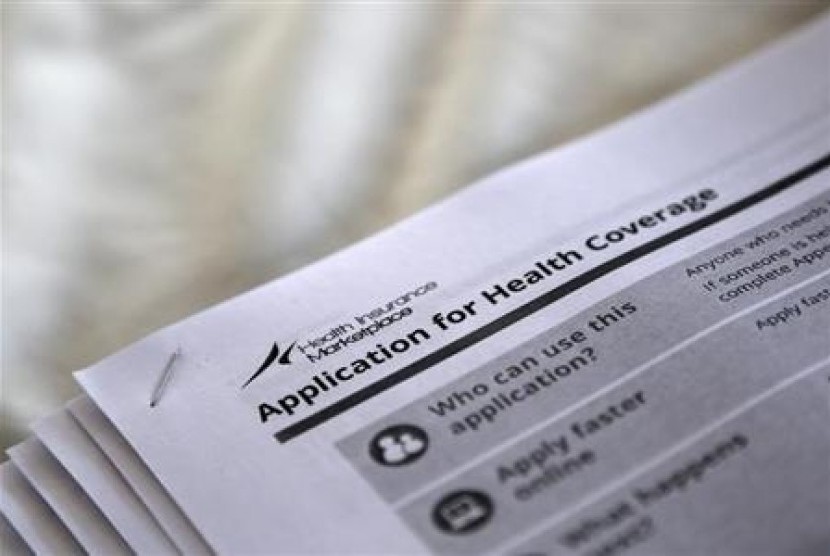 The federal government forms for applying for health coverage are seen at a rally held by supporters of the Affordable Care Act, widely referred to as 