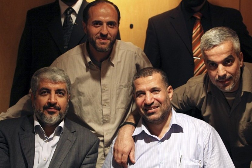 The late Palestinian commander of Hamas, Ahmed Al-Jabari sitsin the front row, second from left (file photo)  