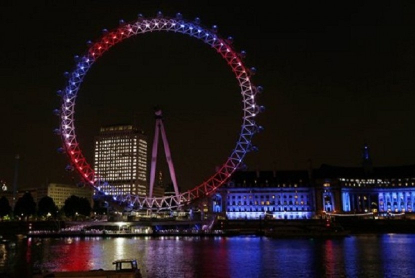 The London Eye observation wheel on the banks of the Thames is lit up in red, blue and white to mark the birth of a baby boy to Prince William and Kate, Duchess of Cambridge, London, Monday, July 22, 2013. 