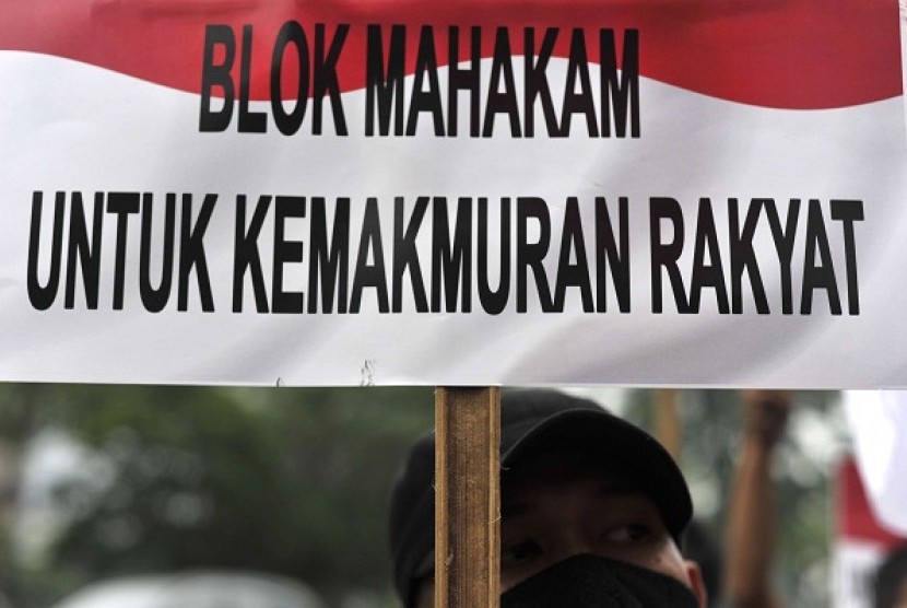 The picture on February 14, 2013 shows a protester in Jakarta brings placard which is translated in English 