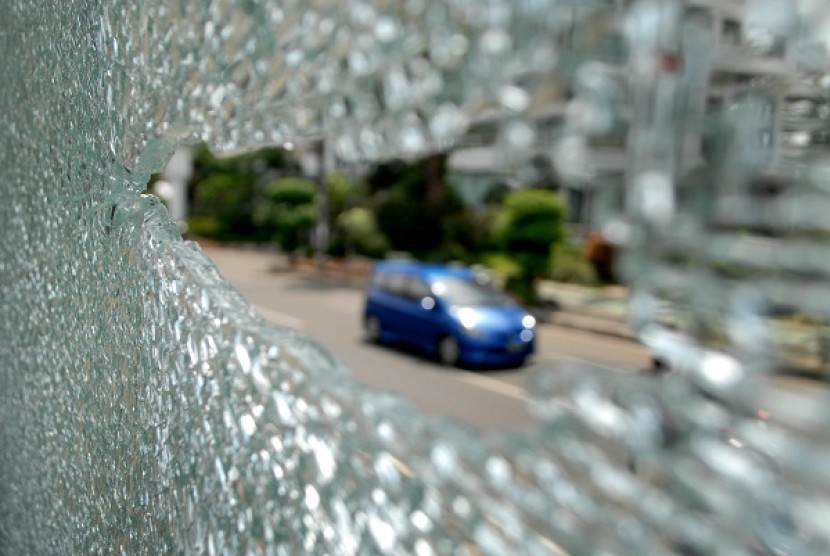 The picture shows broken glass at Trans Jakarta station in MT Haryono Street after an unidentified person shoots at the bus station on early Friday, August 9, 2013.