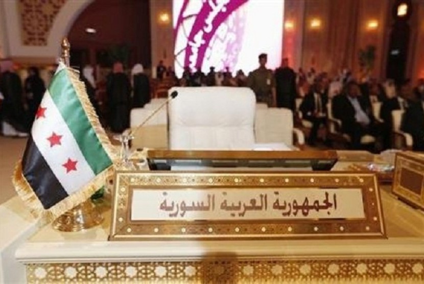 The Syrian opposition flag is seen in front of the seat of the Syrian delegation at the opening the Arab League summit in Doha March 26, 2013. 