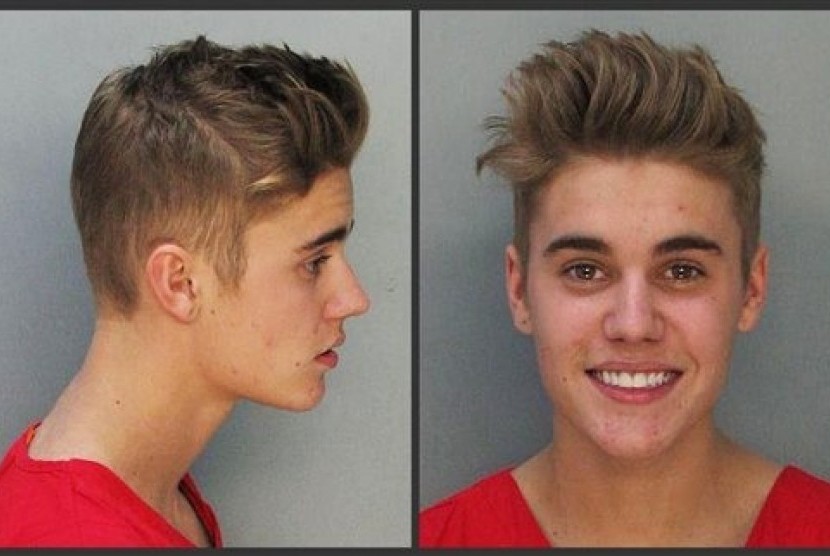 These police booking mugs made available by the Miami Dade County Corrections Department show pop star Justin Bieber, Thursday, Jan. 23, 2014. 