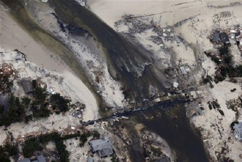 This aerial photo shows a new break in the island across Route 35 at the Herbert Street bridge in Mantoloking, N.J. in the aftermath of Superstorm Sandy Thursday, Nov. 1, 2012. The photo was taken during a National Oceanic and Atmospheric Administration fl