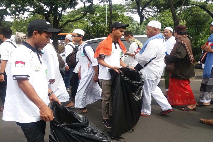 Tim kebersihan Lazismu melakukan bersih-bersih dalam aksi damai 212 di Monas, Jakarta, Jumat (2/12).