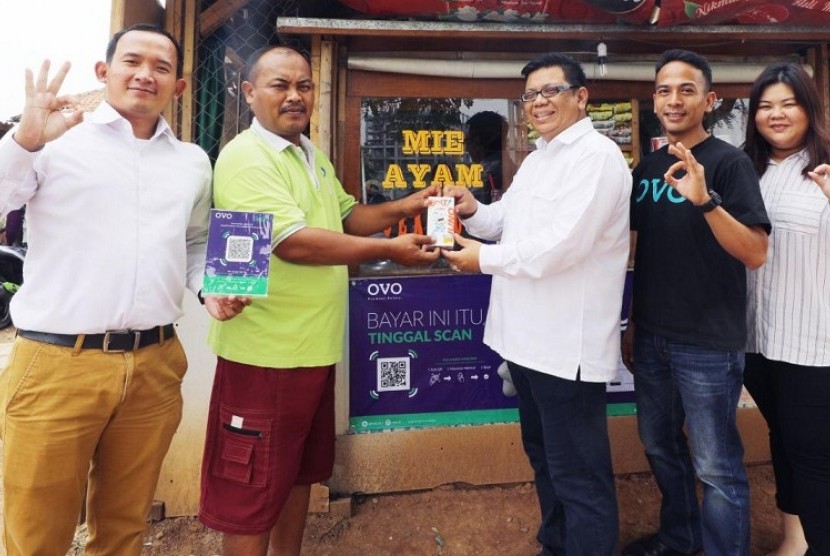Tim Marketing Communication Meikarta menyerahkan QR Code beserta modem Bolt ke salah satu pedagang UKM, pemilik Warung Mie Ayam Gek Sor.