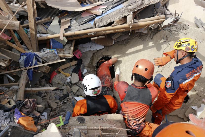 Tim penyelamat mencari korban di bawah reruntuhan bangunan yang runtuh saat gempa (ilustrasi)