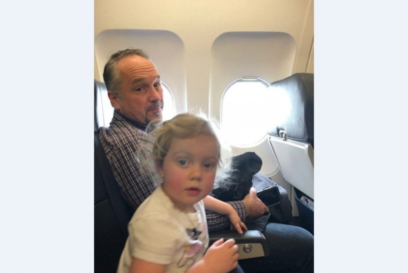 Todd Walker saat membantu salah satu anak Jessica Rudeen di pesawat.