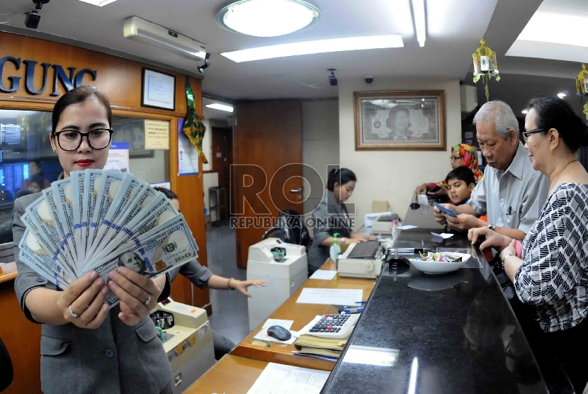  Transaksi penukaran Rupiah terhadap mata uang asing di salah satu tempat penukaran uang, Jakarta, Kamis (23/7).