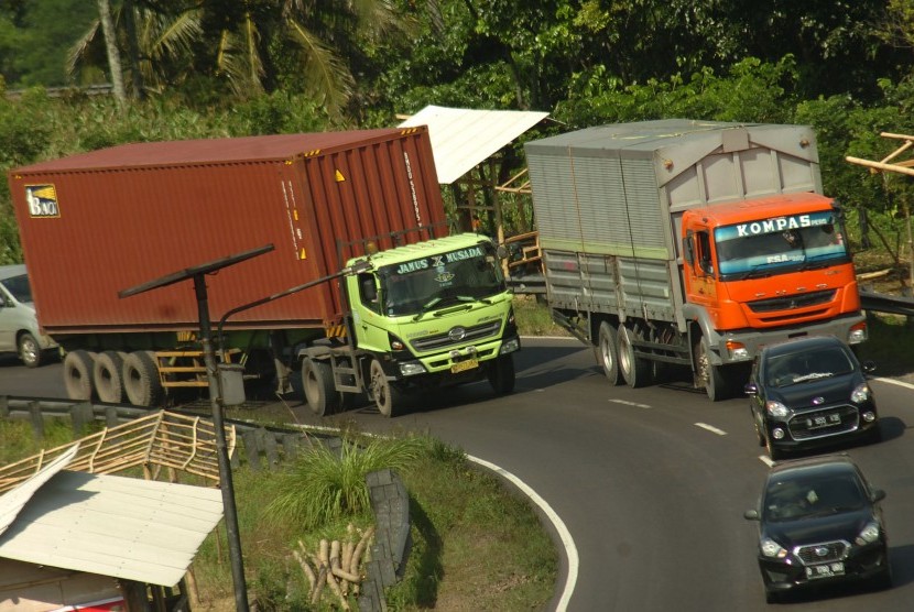 Truk bermuatan besar melintas di jalan. ilustrasi