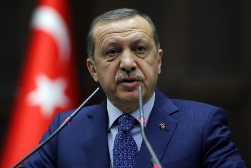 Turkey's Prime Minister Tayyip Erdogan addresses members of parliament from his ruling AK Party (AKP) during a meeting at the Turkish parliament in Ankara February 18, 2014.