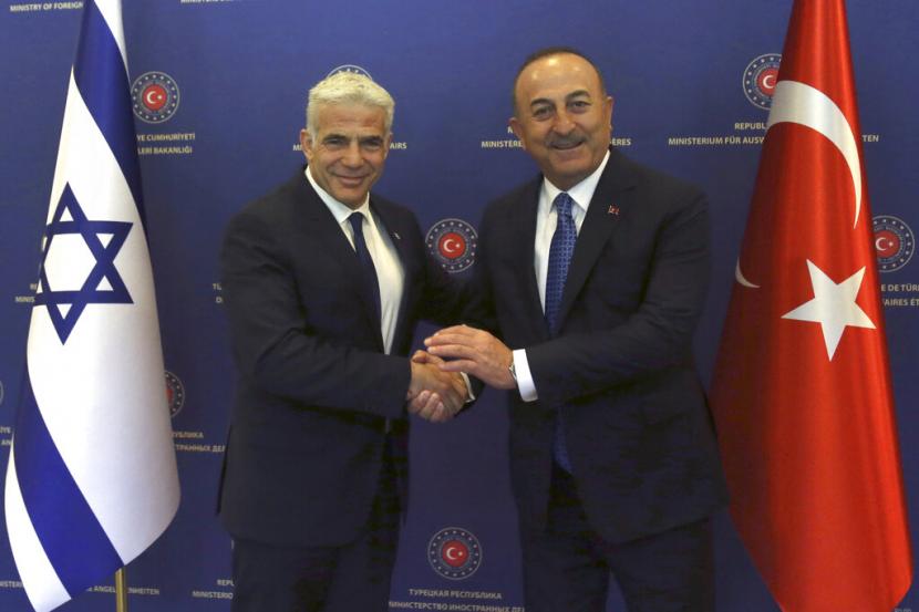Turkish Foreign Minister Mevlut Cavusoglu, right, and Israeli Foreign Minister Yair Lapid pose for photos before their talks, in Ankara, Turkey, June 23, 2022.