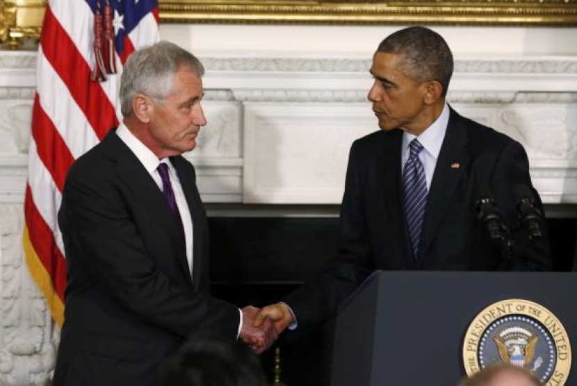 U.S. President Barack Obama (R) greets Defense Secretary Chuck Hagel after announcing Hagel's resignation at the White House in Washington, November 24, 2014. 