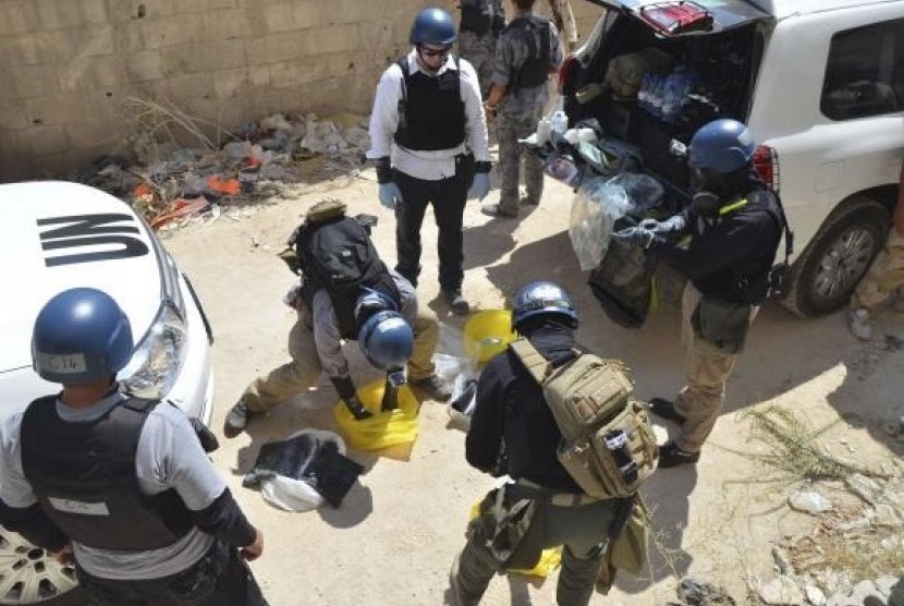 UN chemical weapons experts prepare before collecting samples from one of the sites of an alleged chemical weapons attack.