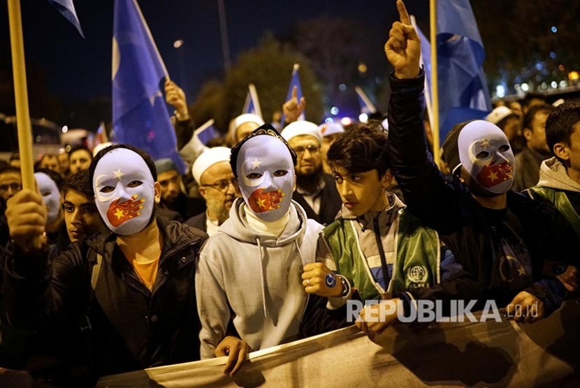 Turki Tepis Kekhawatiran  Deportasi Muslim Uighur ke China. Unjuk rasa mendukung muslim Uighur dan pemain sepakbola Arsenal FC berdarah Turki  Mesut Ozil mengenakan topeng  di Istanbul, Turki. Ilustrasi