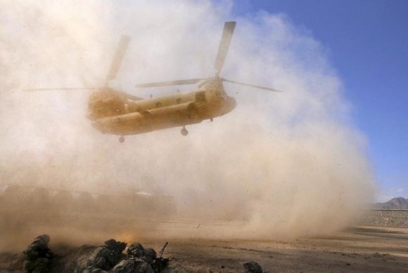 US Army soldiers with the 10th Mountain Division prepare to board a CH-47 Chinook troop transport helicopter after completing their mission at Forward Operating Base Muqar in this US Army picture taken March 14, 2014.