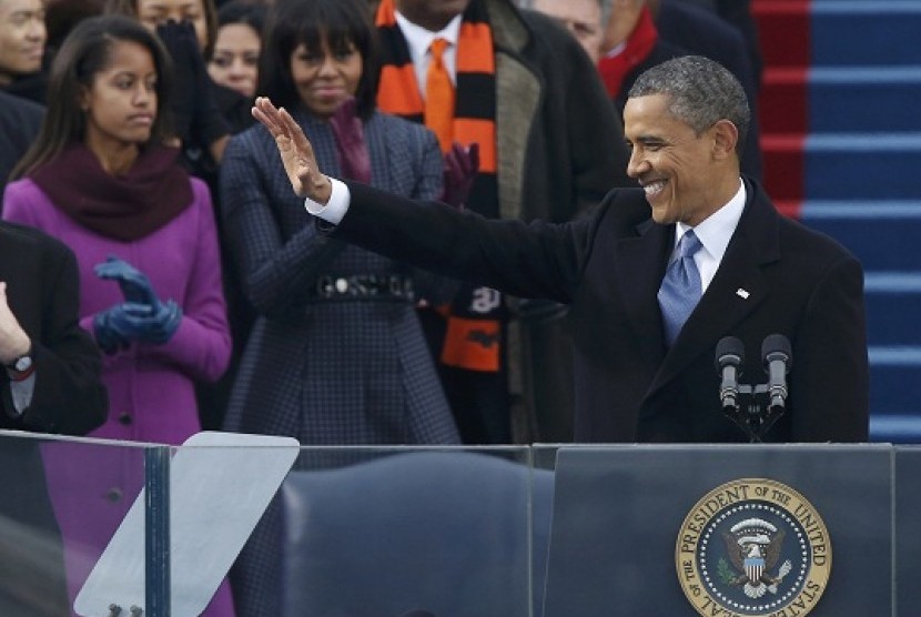 US first lady Michelle Obama applauds and daughter Malia (left) looks on as US President Barack Obama delivers his inaugural address after he took the oath of office during swearing-in ceremonies on the West Front of the U.S. Capitol in Washington, January