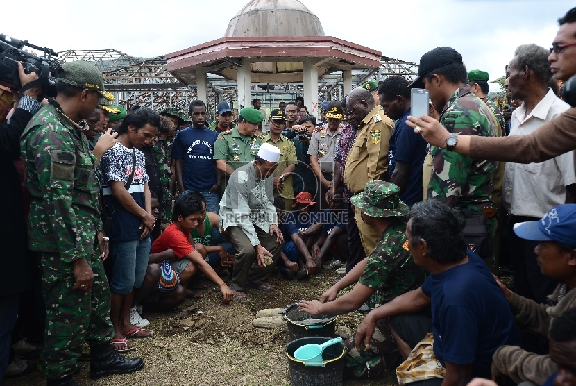 Ustadz Ali Muchtar sebagai pemuka Agama Islam di Tolikara meletakan batu pertama untuk pembangunan kembali kios yang terbakar di Tolikara, Kamis (23/7). 