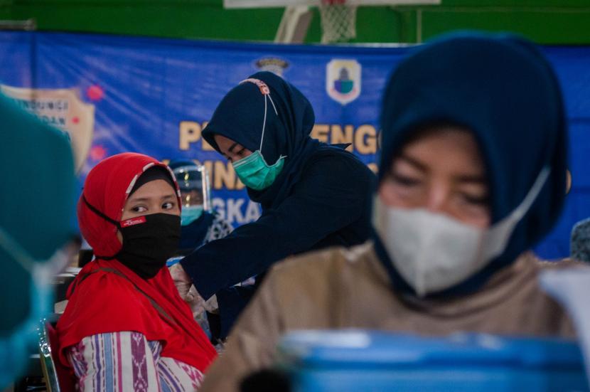Vaksinator menyuntikkan vaksin di Gor Ona, Lebak, Banten, Kamis (3/6/2021). Pemerintah Kabupaten Lebak menggelar vaksinasi COVID-19 secara massal dengan menyasar warga lanjut usia (lansia), pelayan publik, guru PNS/non PNS, dan guru swasta.