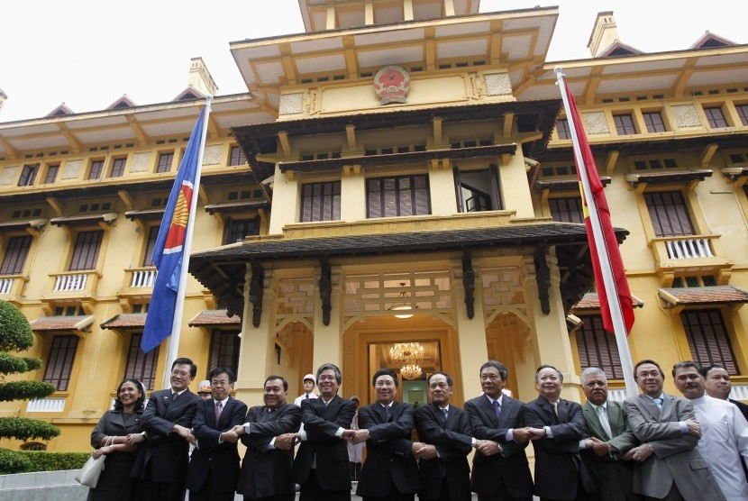 Vietnam's Foreign Minister Pham Binh Minh (center L), Vice Foreign Ministers Pham Quang Vinh (5th L) and Le Luong Minh (Center R) pose for a photo with ASEAN ambassadors to Vietnam in Hanoi August 8, 2012. They were attending a flag raising ceremony to mar
